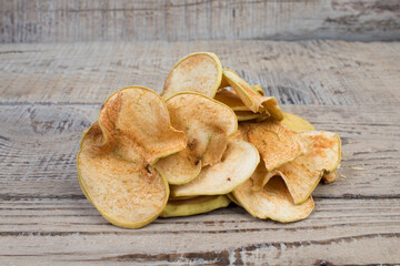 Sliced, dried apples isolated on wooden background. Homemade organic apple.