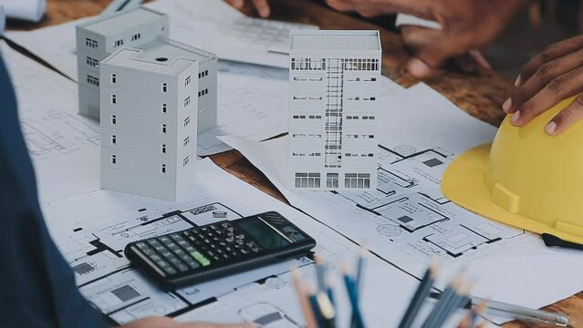 Architectural engineer team meeting Use of blueprints, construction drawings and calculations for architectural projects and engineering tools in the workplace technical structure concept.