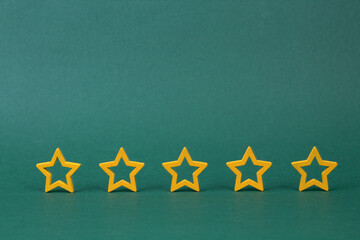 Gold, gray, silver five stars shape on a green background. The best excellent business services...