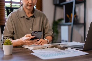 Obraz premium Casual business women using smartphone to researching data and working about marketing strategy