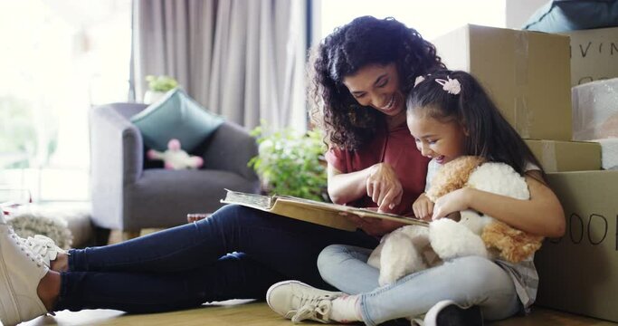 Photo album, new home and mother with girl on the floor, relax and conversation with memory, smile and nostalgic with a toy. Family, parent and mama with a kid, childhood and moving in with a bear