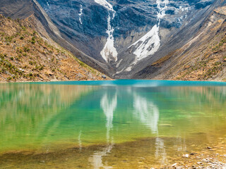 Amazing view of the emerald waters of Humantay lagoon with the glacier in background, Cusco region, Peru - 669542548