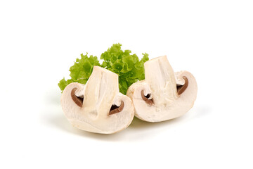 Champignons with lettuce leaf, close-up, isolated on white background.
