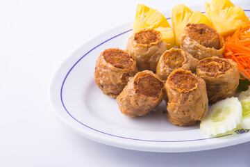 Deep fried crab meat rolls on the white dish.