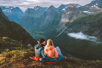Couple in love hiking together romantic vacations with travel camping gear, Man and woman in sleeping bags enjoying mountains landscape outdoor family healthy lifestyle friends exploring Norway - 669555578