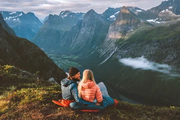 Foto op Plexiglas Couple in love hiking together romantic vacations with travel camping gear, Man and woman in sleeping bags enjoying mountains landscape outdoor family healthy lifestyle friends exploring Norway © EVERST