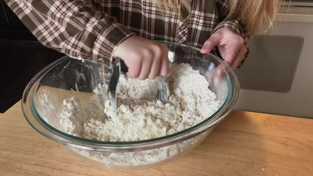 person mixing dough for baking a pie 