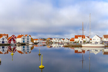 Houses and boats are reflected in the water