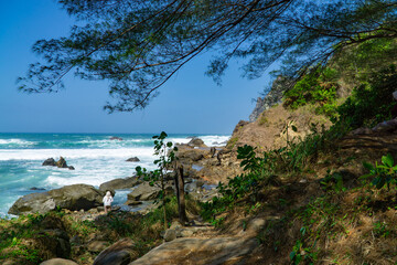 Rocky shoreline of Watu Lumbung Beach, Indonesia. Tidal waves hits the coral rock