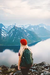 Fotobehang Woman tourist traveling in Norway girl hiking alone outdoor with backpack enjoying mountains view adventure vacations healthy lifestyle sightseeing Senja island © EVERST