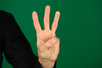 a raised three fingers like a Germany, hand symbol, viewed from back isolated on white background. High quality photo