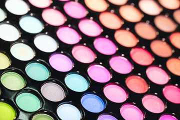 Vibrant professional eyeshadow for make up - close up view. Makeup, beauty, fashion and glamour concept. Professional multicolor makeup eyeshadows palette