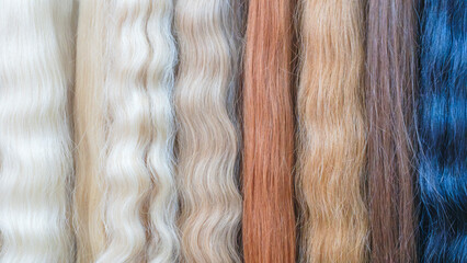 Strands of natural hair in different colors and shades for hair extensions
