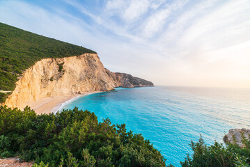 Beautiful beach and water bay in the greek spectacular coast line. Turquoise blue transparent water, unique rocky cliffs, Greece summer top travel destination Lefkada island