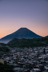 Building in Dieng Regency with beautiful sunrise sky and mountain. Scooter or Skoter Hill, Dieng, Indonesia