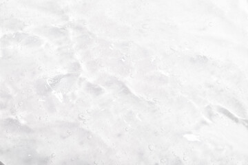 Cosmetic gel, serum transparent sample. Liquid cream with bubble texture. Gel texture of a cosmetic product. Clear liquid lotion for skin care.