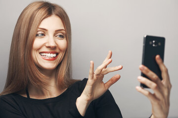 Funny blogger concept. Close up portrait of smiling woman with long chestnut hair, natural make-up,...