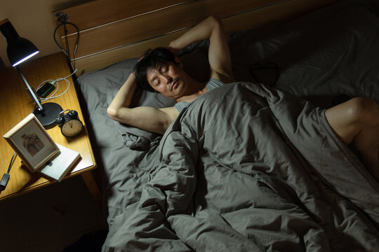 A middle-aged man sleeping in bed