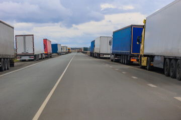 Many trucks parked on the side of road