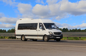 Minibus moves along a country road - 669584713