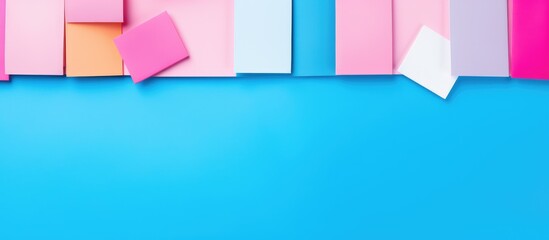 School and office supplies like colored pencils on a blue and pink background in a flat lay top view with room for text