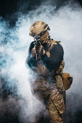 Portrait of a special forces soldier aiming at the collimator sight of a machine gun. The concept...