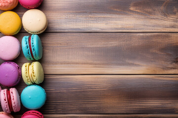 Fototapeta na wymiar Colored macaroon cookies on a wooden background