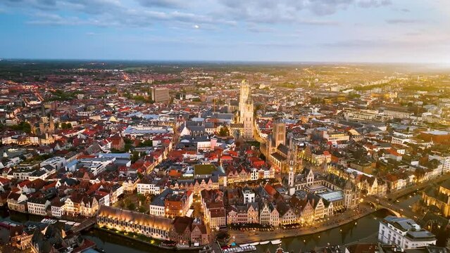 Aerial view of famous places Castle of the Counts next to river Lys. Beautiful architecture and landmarks of the medieval city on a sunset. Ghent, Belgium