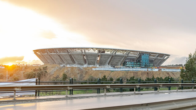 Algiers, Algeria- January 22, 2023: Douera stadium of MCA Algerian soccer club under construction vue from the freeway on cheraga road. Cloudy sky with morning sunlights shining. 