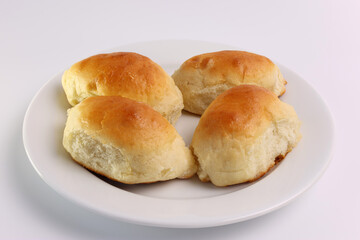 Freshly baked ruddy pies with apple filling on a white plate. Tasty and nutritious pastries. Home cuisine.