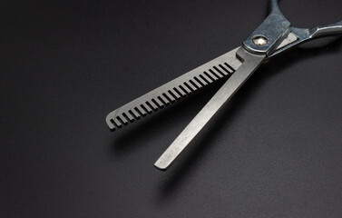 Professional hairdressers equipment. Hairdresser tools. Hairdresser salon concept. Haircut accessories. Hairdressing scissors on black background.