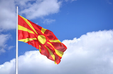 Macedonian Flag - It portrays a yellow sun with rays on a red background. The eight rays extend...