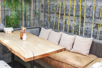 Outdoor Cafe tables and chairs set made of wood and rattan. Natural interior design concept for...