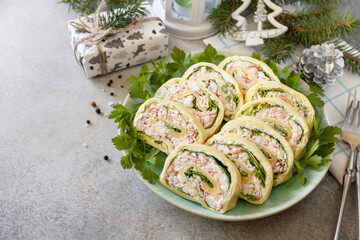 Creative appetizers christmas. Cheese roll with crab sticks, cream cheese and eggs. Copy space.