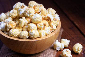Close up Popcorn in the wooden bowl on wooden background