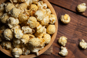 Close up Popcorn in the wooden bowl on wooden background
