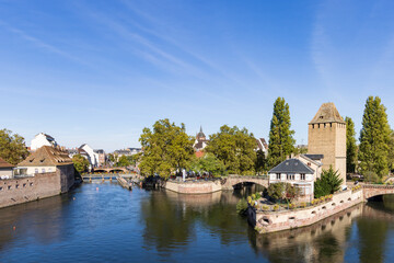 Fototapeta na wymiar Barrage Vauban and tourist cruise ship scenic view of Strasbourg in Elsace region along the Rhine river in France