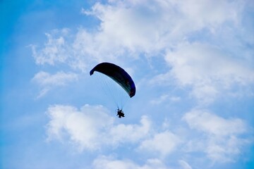 silhouette of paraplane on evening sky background