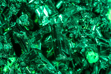 Green crystal mineral stone. Gems. Mineral crystals in the natural environment. Texture of precious...