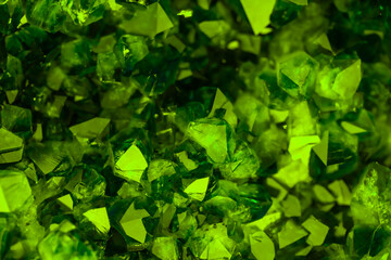 Green crystal mineral stone. Gems. Mineral crystals in the natural environment. Texture of precious and semiprecious stones. Seamless background with copy space colored shiny surface of precious stone