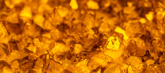 Golden crystal mineral stone. Gems. Mineral crystals in the natural environment. Texture of precious and semiprecious stones. Seamless background with copy space.