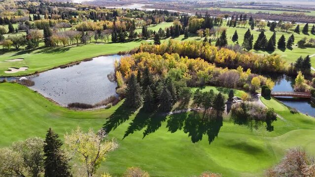 Soar above the Riverside Country Golf Course in Saskatoon. The drone footage beautifully captures its manicured greens, winding fairways, and the adjacent river's edge.