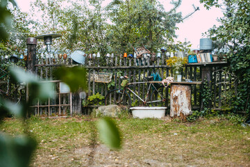 Old bike and wooden fence surrounded by greenery