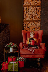 Little boy with christmas tree and gifts