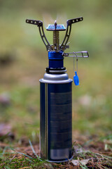 Tourist gas burner for cooking. Tourist equipment. Outdoor camping.