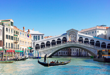 view of famouse Rialto bridge with gondola boats in Venice, Italy