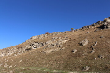 A rocky hill with a hill and blue sky