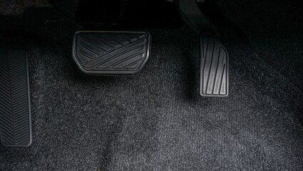 Close-up of the brake and accelerator pedals of an automatic transmission car.