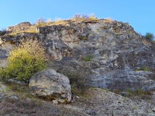 Fototapeta na wymiar A rocky mountain with a tree