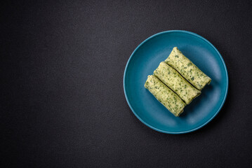 Delicious fresh pancakes with spinach, cream cheese, salmon, salt and spices